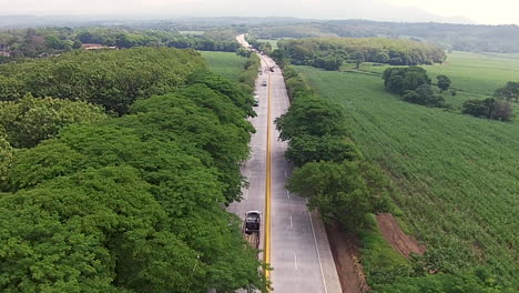 Aerial-shot-over-a-long-road-in-the-countryside-of-El-Salvador