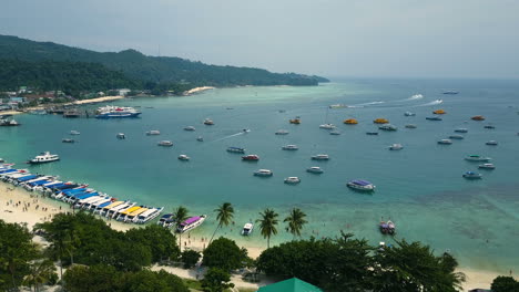 Aerial-footage-of-beach-shore-and-many-sailing-boats-in-Krabi