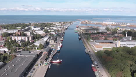 Aerial-view-of-fishing-ships-at-river-canal-by-Baltic-Sea-in-Liepaja,-Latvia