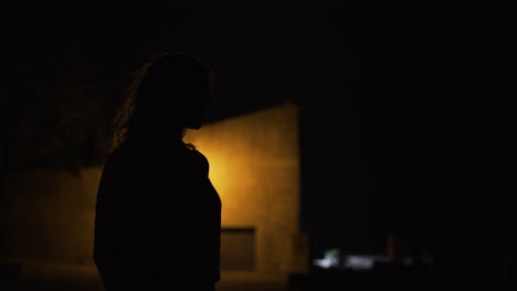 Silhouette-of-woman-at-night-in-Mallorca,-Spain