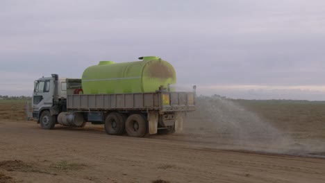 Water-Truck-drives-away-from-camera-attempting-to-keep-dust-at-bay