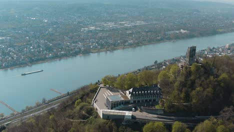 Drone-shot-of-the-Drachenfels-with-the-river-rhine-and-a-ship-Siebengebirge-near-Bonn---Königswinter