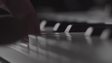 Playing-piano-keys-on-MIDI-keyboard-in-home-recording-studio