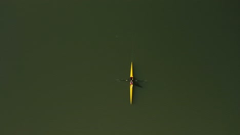 Aerial-view-of-crew-member-rowing-her-boat