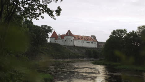 Bauska-Castle-by-river-at-sunset