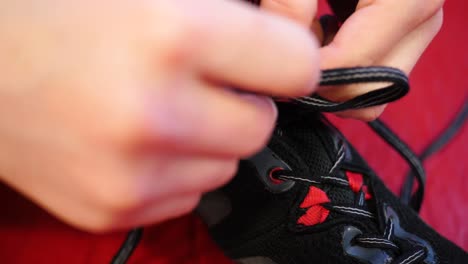 Close-up-of-a-person-tying-the-laces-on-a-wrestling-shoe