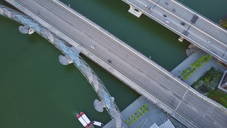 Aerial-of-cars-driving-on-a-bridge-near-river