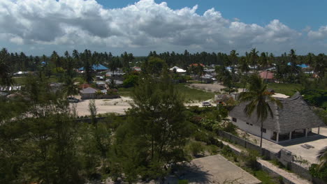 Flying-above-luxury-bungalows-on-exotic-Zanzibar-island-with-cloud-sky