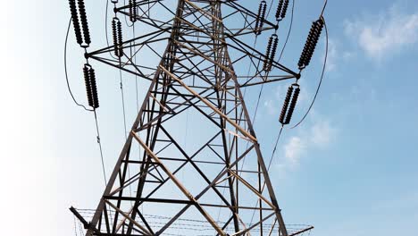 High-Power-Electric-Line-Tower-During-an-Afternoon-Panned-Through-its-Height