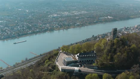 Drone-shot-of-the-Drachenfels-with-the-river-rhine-and-a-ship-Siebengebirge-near-Bonn---Königswinter