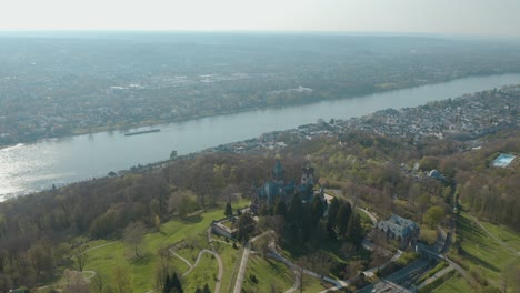 Drone---Aerial-shot-of-the-castle-Drachenburg-and-the-river-rhine-with-a-ship-Siebengebirge-near-Bonn---Königswinter-30p
