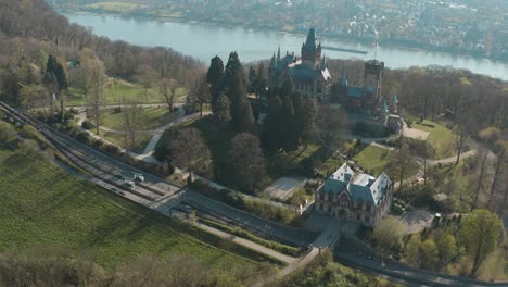 Drone---Aerial-shot-of-the-castle-Drachenburg-and-the-river-rhine-with-ship-Siebengebirge-near-Bonn---Königswinter-30p