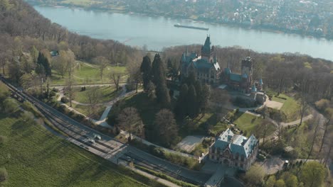 Drone---Aerial-shot-of-the-castle-Drachenburg-and-the-river-rhine-with-a-ship-Siebengebirge-near-Bonn---Königswinter-25p
