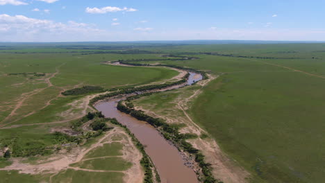 Aerial-of-African-savannah-and-river-during-sunny-day-in-Serengeti