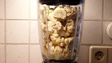 Slow-motion-clip-of-a-chopped-cauliflower-beeing-processed-in-a-food-proccesor
