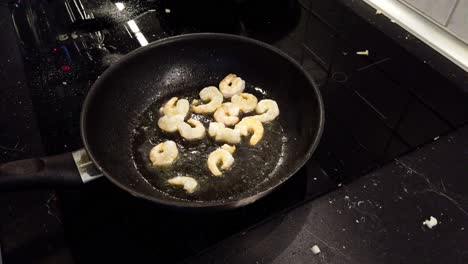 Frying-a-few-shrimps-in-a-black-pan