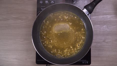 Preparing-homemade-sauce-on-frying-pan,-adding-ingredients