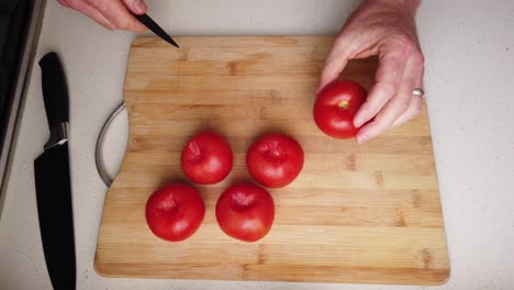 Time-lapse-of-chef-preparing-to-roast-tomatoes-with-balsamic-vinegar-and-garlic