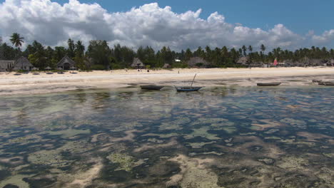 Drone-flying-above-ocean-to-luxury-bungalows-on-exotic-Zanzibar-island