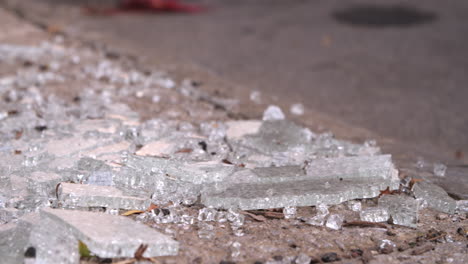 Close-up-slider-shot-of-shattered-glass-on-a-city-street