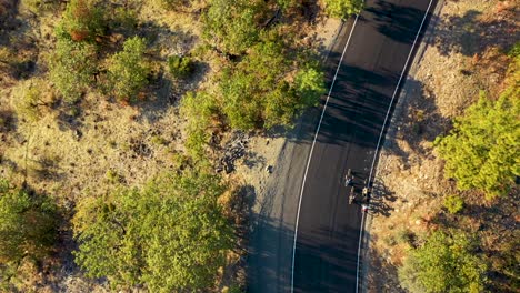 Aerial-view-of-mountain-bikers-riding-on-a-gravel-trail