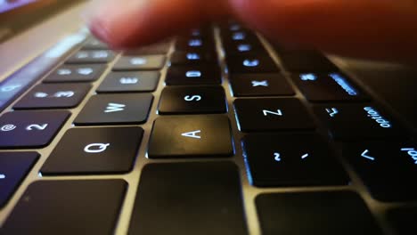 Close-up-shot-of-fingers-typing-on-laptop-keyboard-and-scrolling-and-clicking-on-trackpad