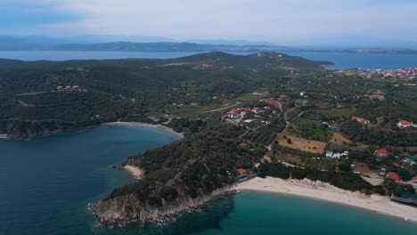 Circling-drone-shot-of-Ouranoupoli-forest-and-beach