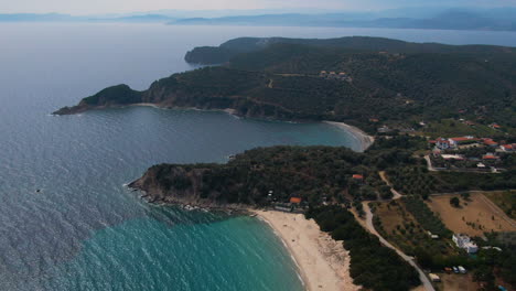 Circling-drone-shot-of-Ouranoupoli-forest-and-beach