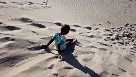 Little-boy-playing-on-sand-dunes-in-South-Africa