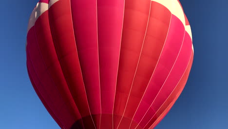 Closeup-of-hot-air-balloon-in-flight,-burner-on