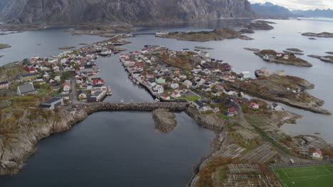 Overhead-drone-shot-of-nordic-Norwegian-island-archipelago-village-with-football-soccer-field