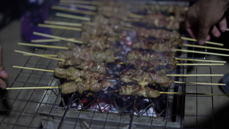 flipping---grilling-meat-skewers-on-a-charcoal-grill----pan-shot