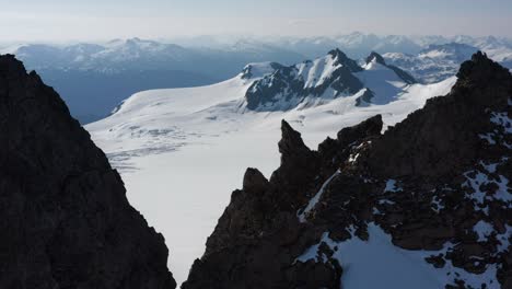 Drone-pan-reveal-of-summer-glacier-in-British-Columbia,-Canada