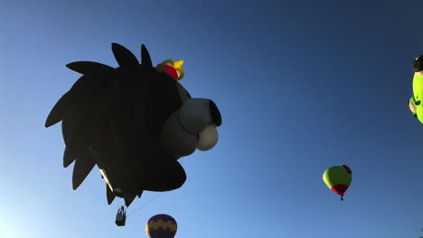 Frog-and-Lion-balloons-lift-off-and-float-over-the-trees