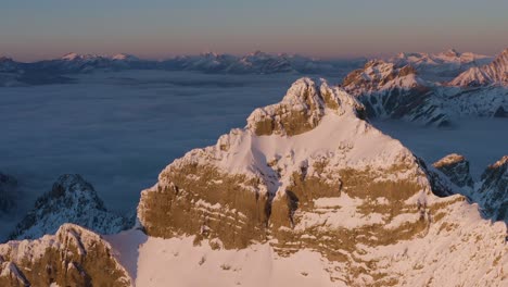 Beautiful-snow-covered-peak-sideways-drone-pan-during-sunset-inversion-in-British-Columbia