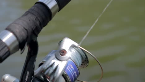 Fisherman-spinning-reel-on-Rod