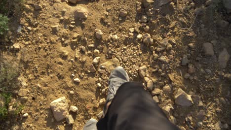 Slow-motion-video-of-a-man-walking-in-grey-trainers-in-the-mountains