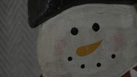 slow-up-pan-of-a-wooden-snowman-decoration-for-christmas
