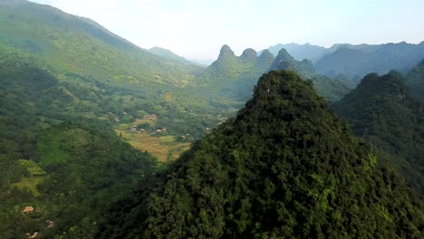 Aerial-parallax-view-of-green-forested-hills-and-landscape-of-Vietnam