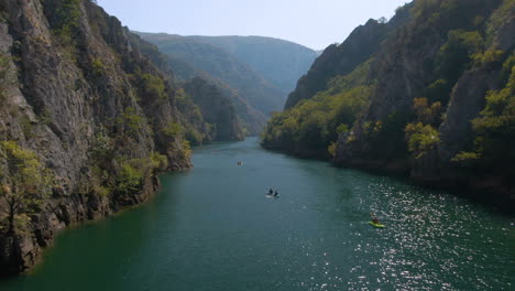 Aerial-footage-of-people-canoeing-in-Matka-canyon-in-Macedonia-on-a-sunny-day