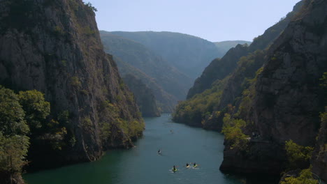 Aerial-footage-of-people-canoeing-in-Matka-canyon-in-Macedonia-on-a-sunny-day