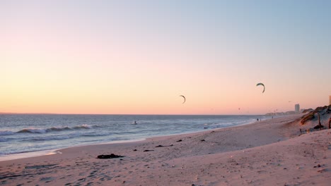 Kite-surfing-surfers-sails-on-the-ocean-wave-at-sunset,-Bloubergstrand,-Cape-town-South-Africa