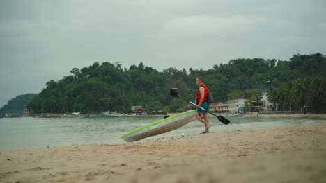 Tourist-Getting-Ready-To-Ride-Kayak-On-The-Beach-In-A-Hot-Summer-Day-In-El-Nido-Palawan---Medium-shot