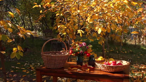 Table-with-baskets-of-walnuts-and-red-ripe-pomegranates-during-autumn-thanksgiving