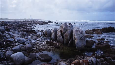 rocky-formations-at-Hangklip-bay-with-lighthouse-in-background