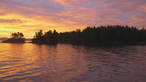 Amazon-sunrise-on-remote-lonely-bay-deep-in-Great-Bear-Rainforest,-Canada,-Pacfic