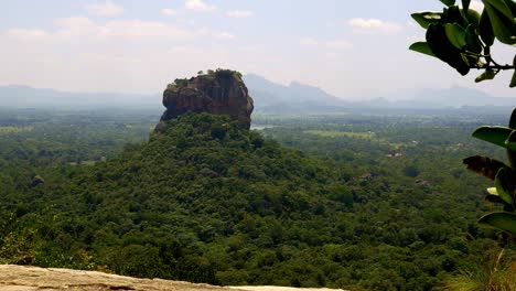 View-on-ancient-Pinnawala-mountain-from-far-away,-surrounded-by-rainforest