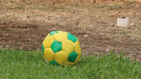 Old-soccer-ball-on-grass-close-up