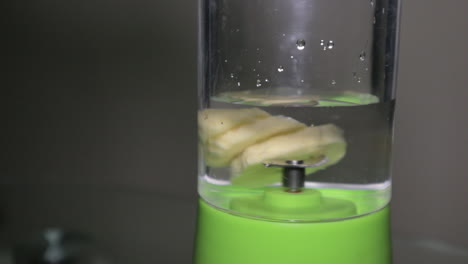 Slices-Of-Banana-With-Liquid-Put-In-The-Blender-Ready-For-Making-Fruit-Shake---Close-Up-Shot
