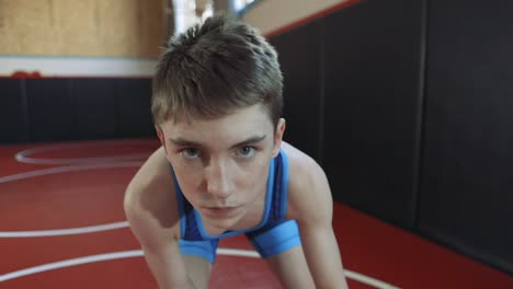 Teenage-wrestler-wearing-a-blue-singlet-coming-into-and-going-out-of-focus